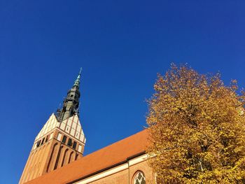 Low angle view of st. nicholas church against clear blue sky