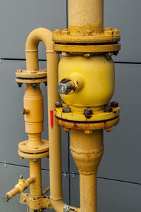 Close-up of fire hydrant against wall