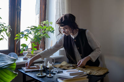 Side view of man working at table