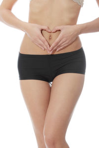 Midsection of woman standing against white background