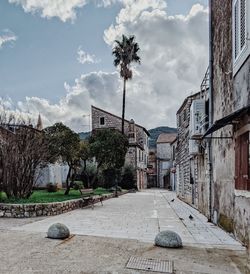 Street amidst buildings against sky