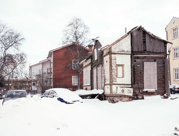 Houses against sky during winter