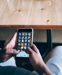 Midsection of man holding smart phone