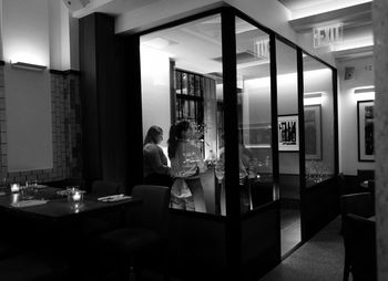 Rear view of man looking through window