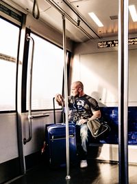 Full length of man traveling in train