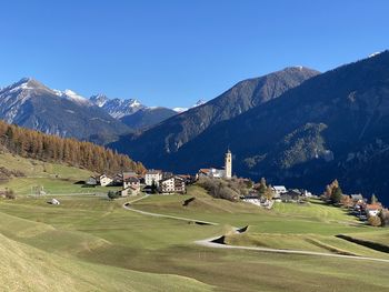 Scenic view of buildings and mountains against clear sky