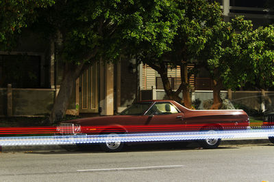 Vintage classic american muscle  pick up truck car and light trails  in venice beach, california 