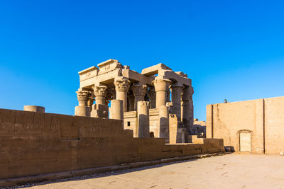 Low angle view of historical building against clear blue sky