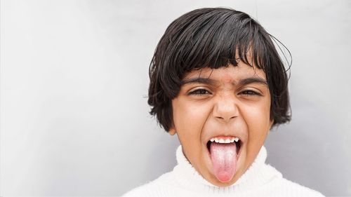 Photo of funky happy cheerful young little girl make funny face good mood isolated on gray color 