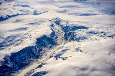 Aerial view of snowcapped mountains against sky