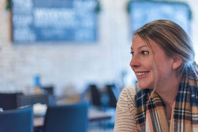 Close-up of smiling beautiful woman looking away