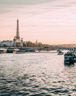 View of city at waterfront during sunset