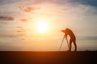 Man with camera during sunset