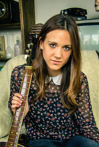 Portrait of beautiful woman holding camera