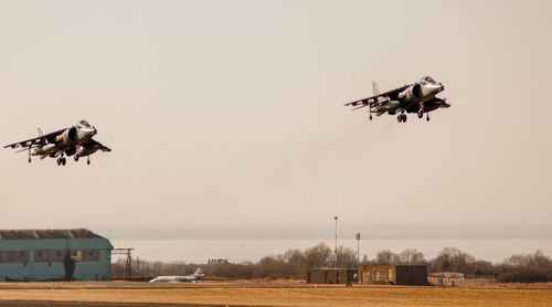 Low angle view of airplane flying against sky