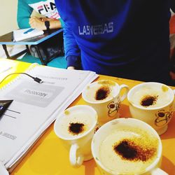 Man holding coffee cup on table