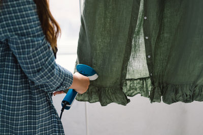 Midsection of woman standing in workshop