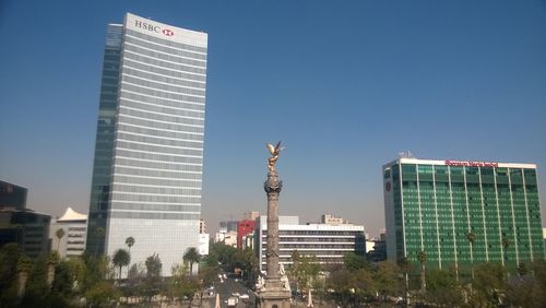 Low angle view of skyscraper against clear blue sky