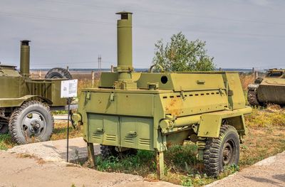 Abandoned truck on field against sky