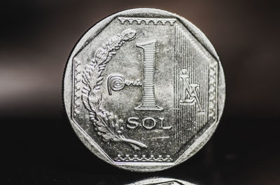Close-up of coin against black background