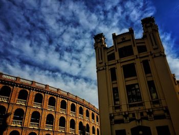 Low angle view of building against cloudy sky