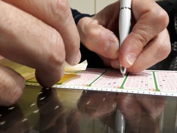 Midsection of man holding paper