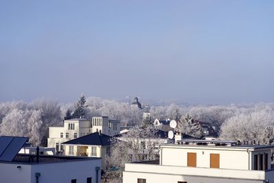 Houses in city against sky