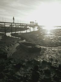 People on beach against sky