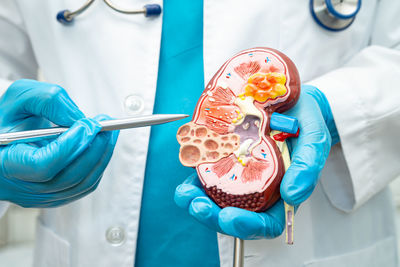 Midsection of scientist examining patient