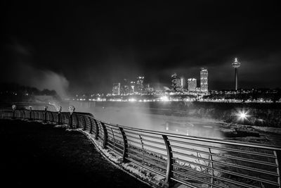 Distant view of illuminated city seen from observation point at night