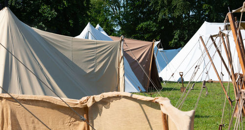 Clothes drying on field against trees