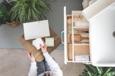 Low section of woman using digital tablet while sitting at home