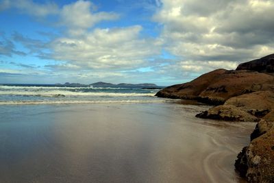 Scenic view of sea against cloudy sky