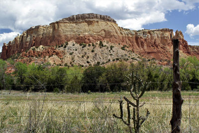 View of rock formations against cloudy sky