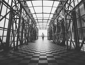 Man walking on metal bridge