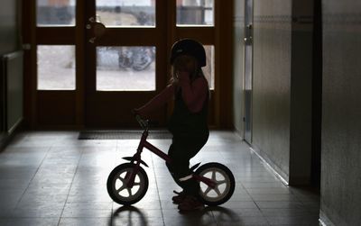 Full length girl with bicycle in corridor