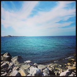 Scenic view of sea against cloudy sky