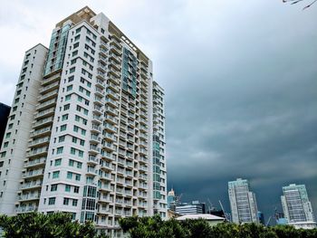 Low angle view of modern buildings in city against sky