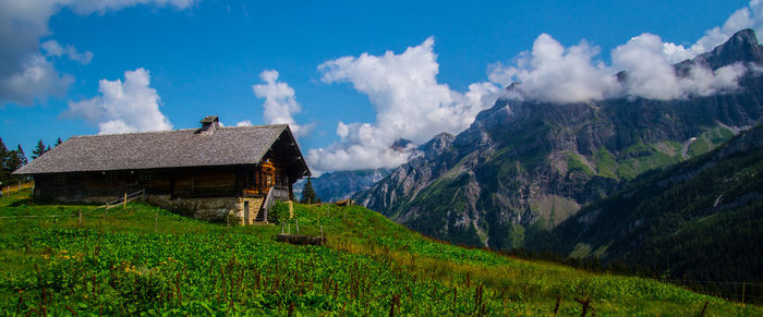 Panoramic view of house and mountains against sky