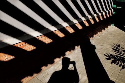 High angle view of shadow on floor in city