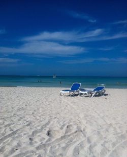 Scenic view of beach against blue sky