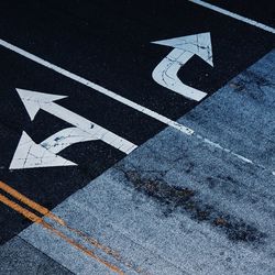 High angle view of arrow symbol on road