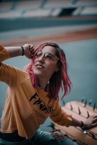 Woman with dyed hair looking away