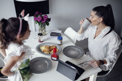 Mother and daughter at dining table