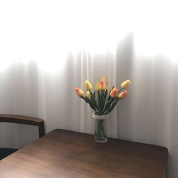 Close-up of tulips in vase on table