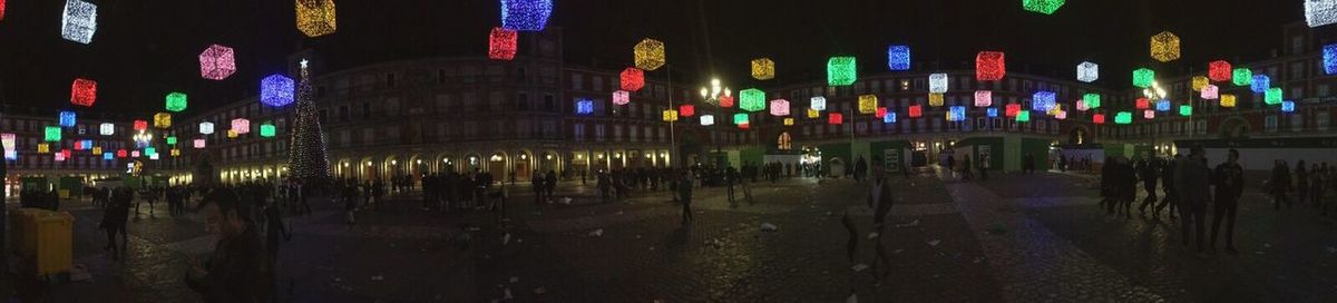 People in illuminated city at night