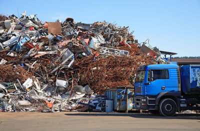 Truck against scrap metals at junkyard