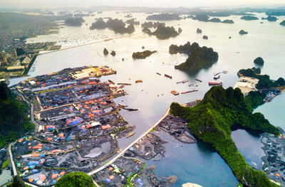 High angle view of cityscape by sea against sky