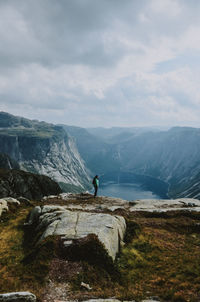 Man looking at mountain against sky