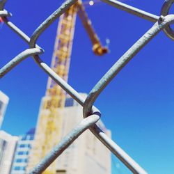 Close-up of metal against blue sky